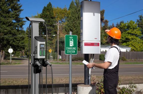 Technician performing maintenance inspection on EV charger