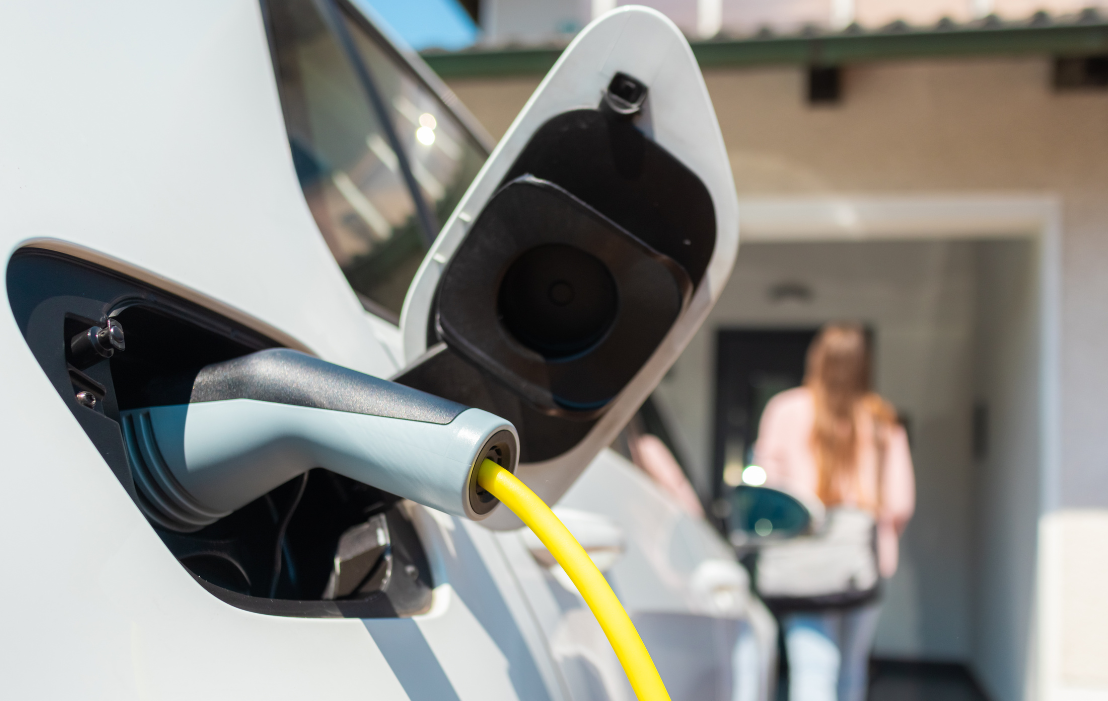 An electric car is being charged in a garage.