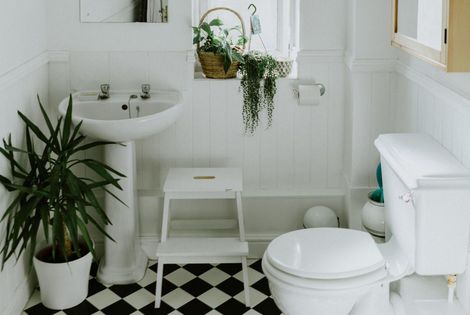 Basic bathroom renovation with simple fixtures, new paint, and affordable tile updates by Do-All Group.