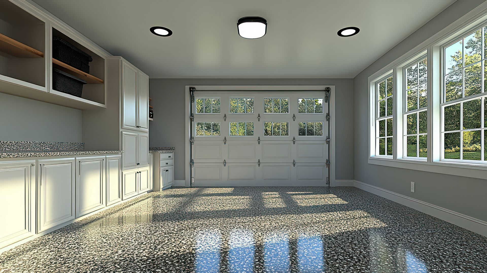 A residential garage with cabinet space and an epoxy-based flooring system