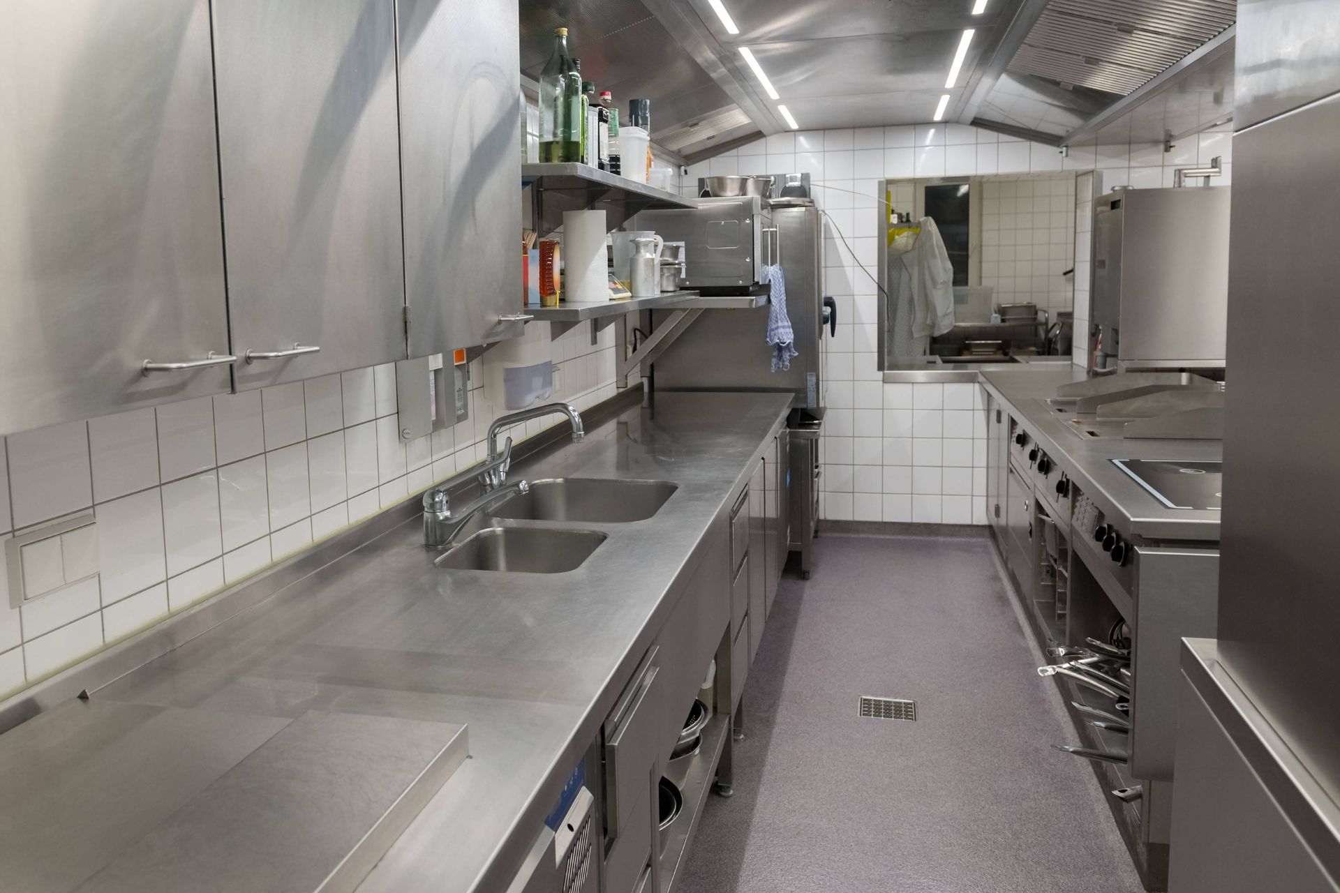 A restaurant kitchen with a custom concrete coating floor 