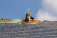 worker repairing the roof