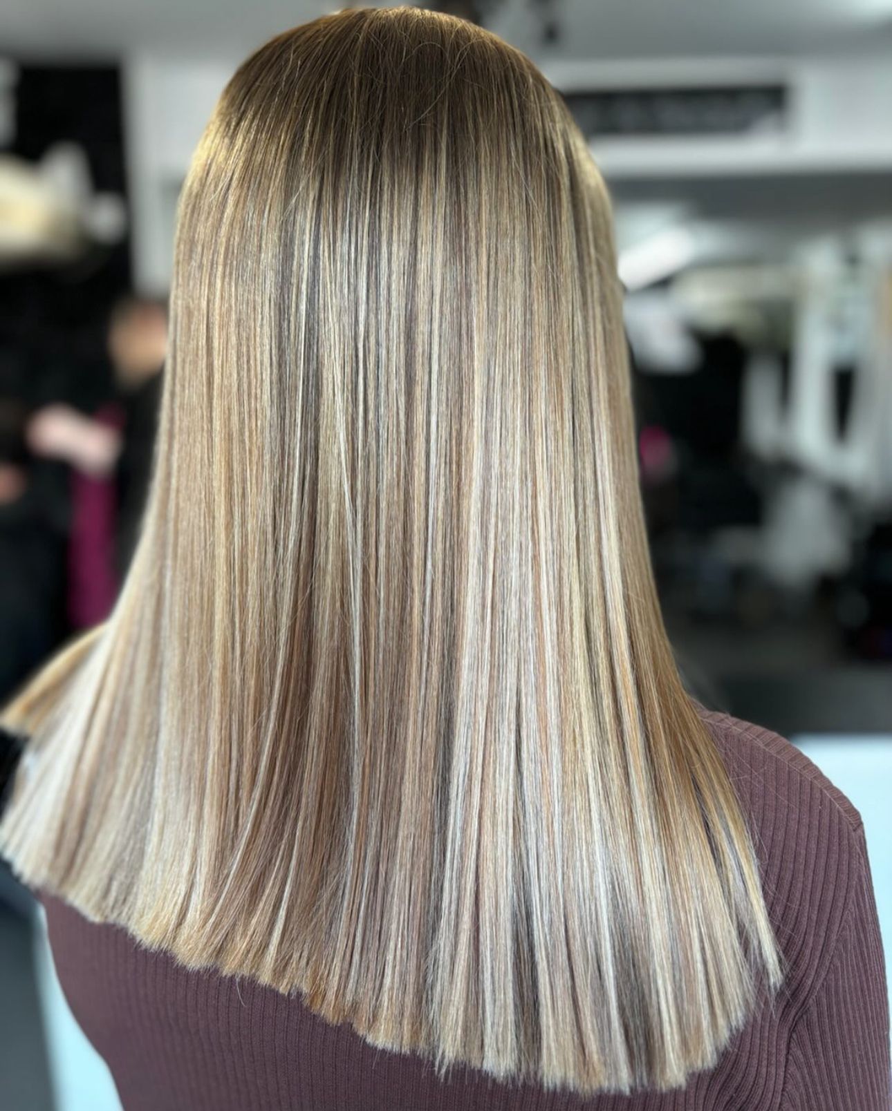 A woman with a professional scissor hair cut at a hair salon in toddington