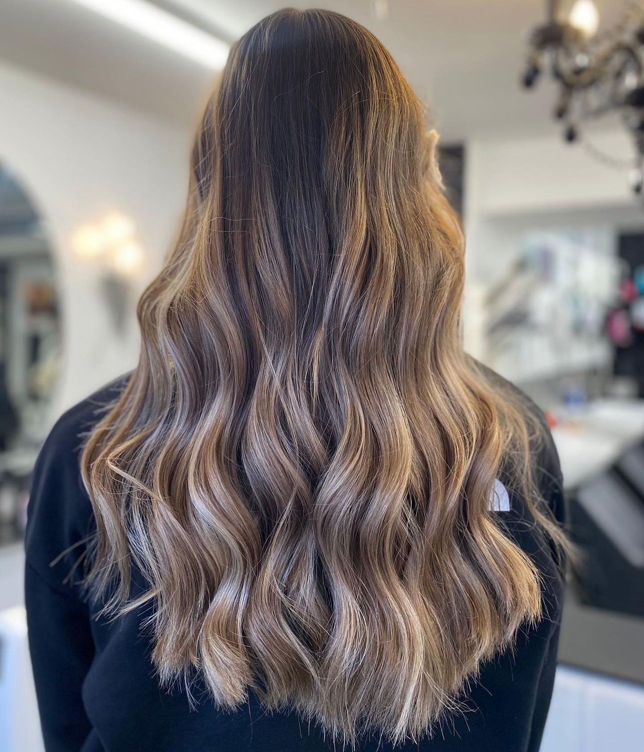 A woman has had balayage and a hair cut at a hair salon in toddington