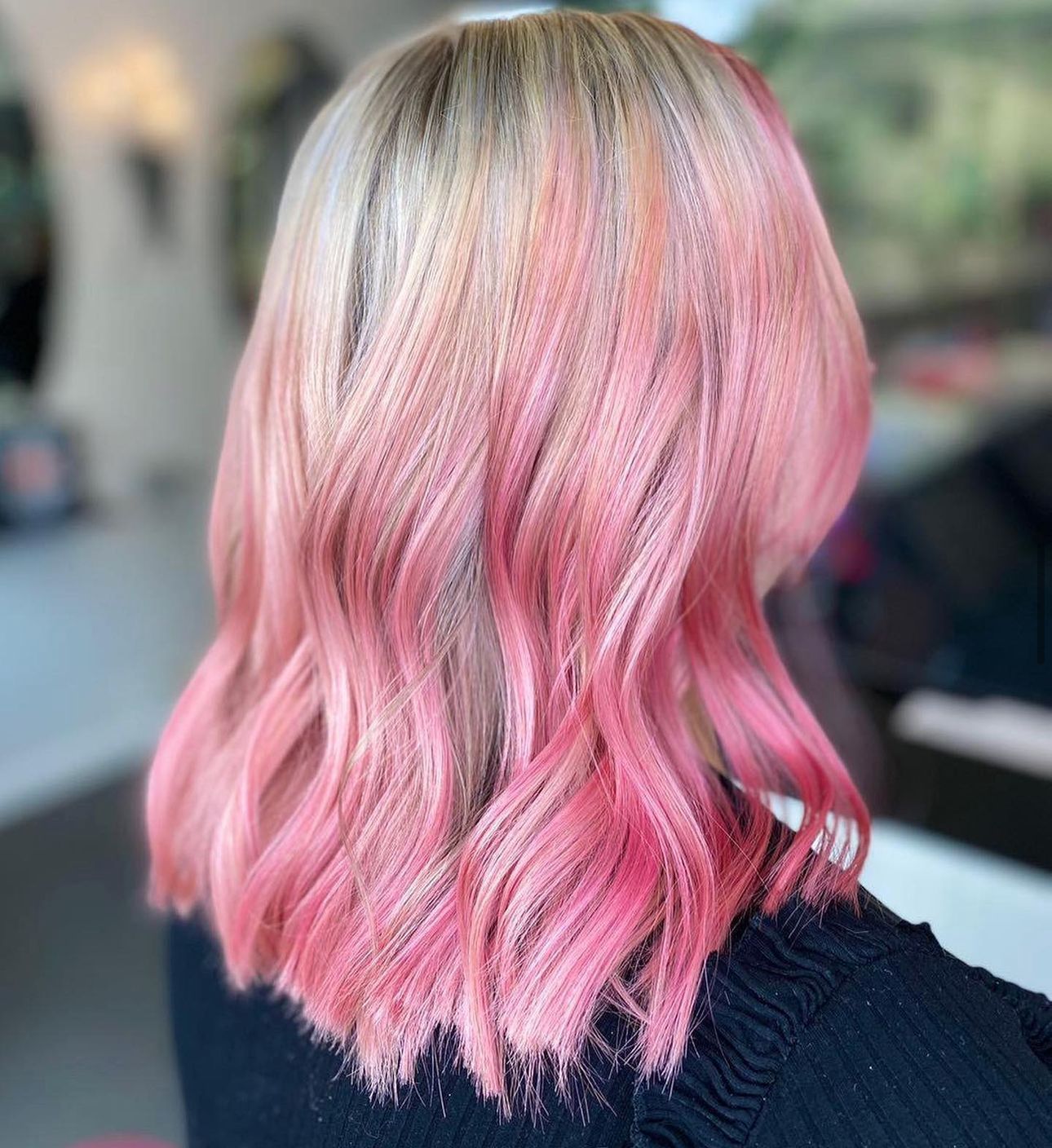 a woman with pink hair has had professional hair colouring at panache hair and beauty in toddington
