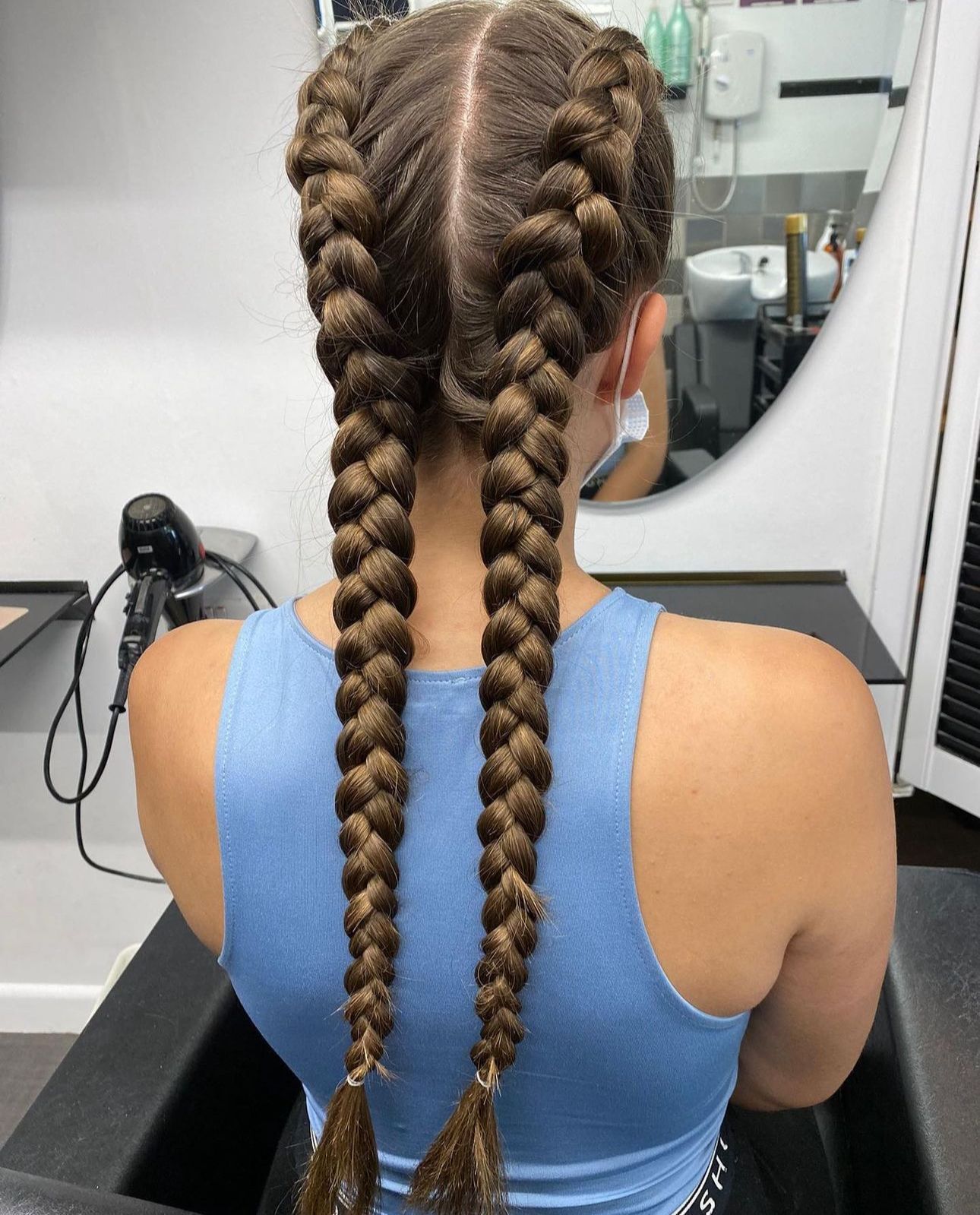 A woman with french braids at panache hair and beauty salon