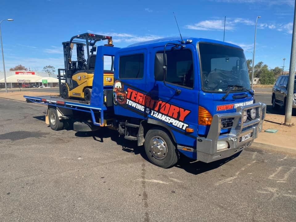 A Blue Tow Truck With A Forklift On The Back Is Parked On The Side Of The Road — Territory Towing & Transport In Alice Springs, NT