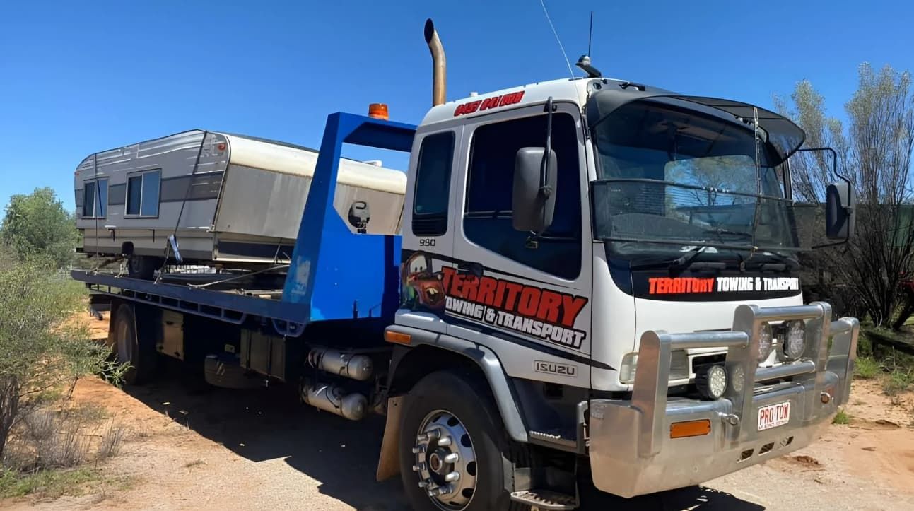 A Tow Truck Is Carrying A Trailer On The Back Of It — Territory Towing & Transport In Alice Springs, NT
