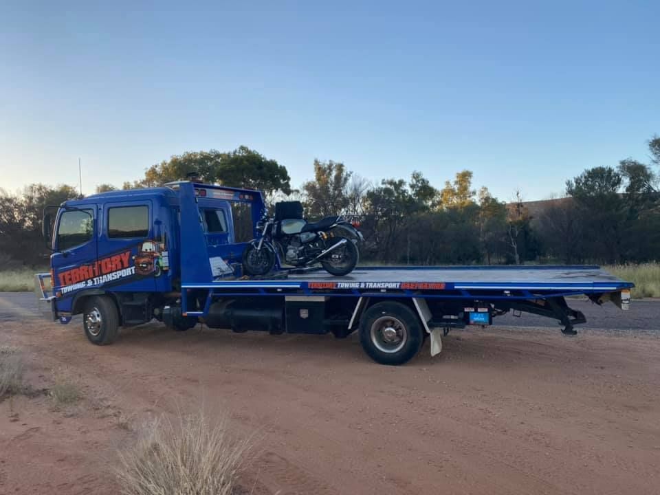 A Blue Tow Truck With A Motorcycle On The Back Of It — Territory Towing & Transport In Alice Springs, NT
