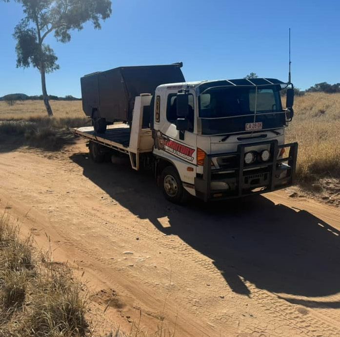 A Tow Truck Is Parked On The Side Of A Dirt Road — Territory Towing & Transport In Alice Springs, NT