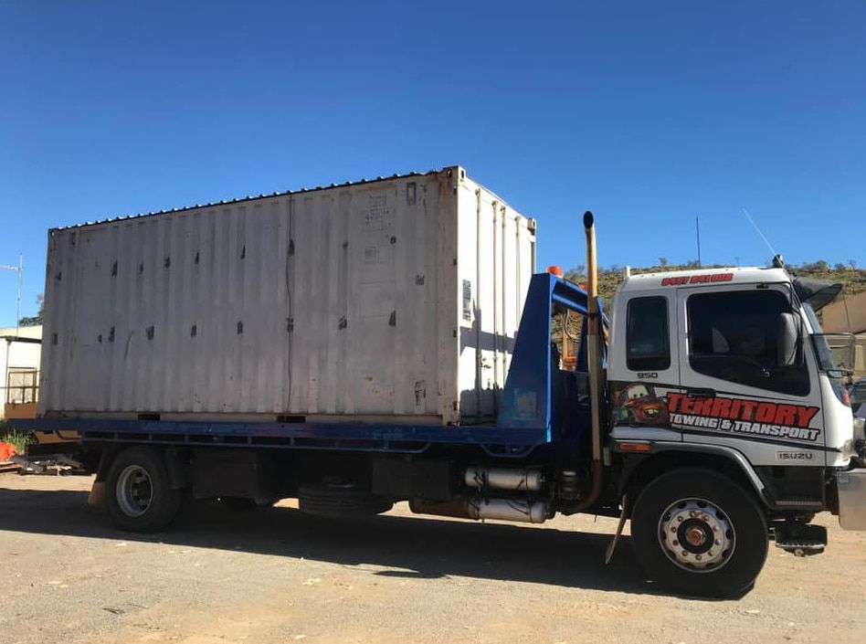 A Tow Truck With A Container On The Back Is Parked In A Parking Lot — Territory Towing & Transport In Alice Springs, NT