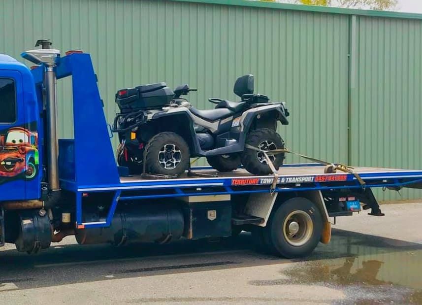 A Blue Tow Truck With A Four Wheeler On The Back — Territory Towing & Transport In Alice Springs, NT