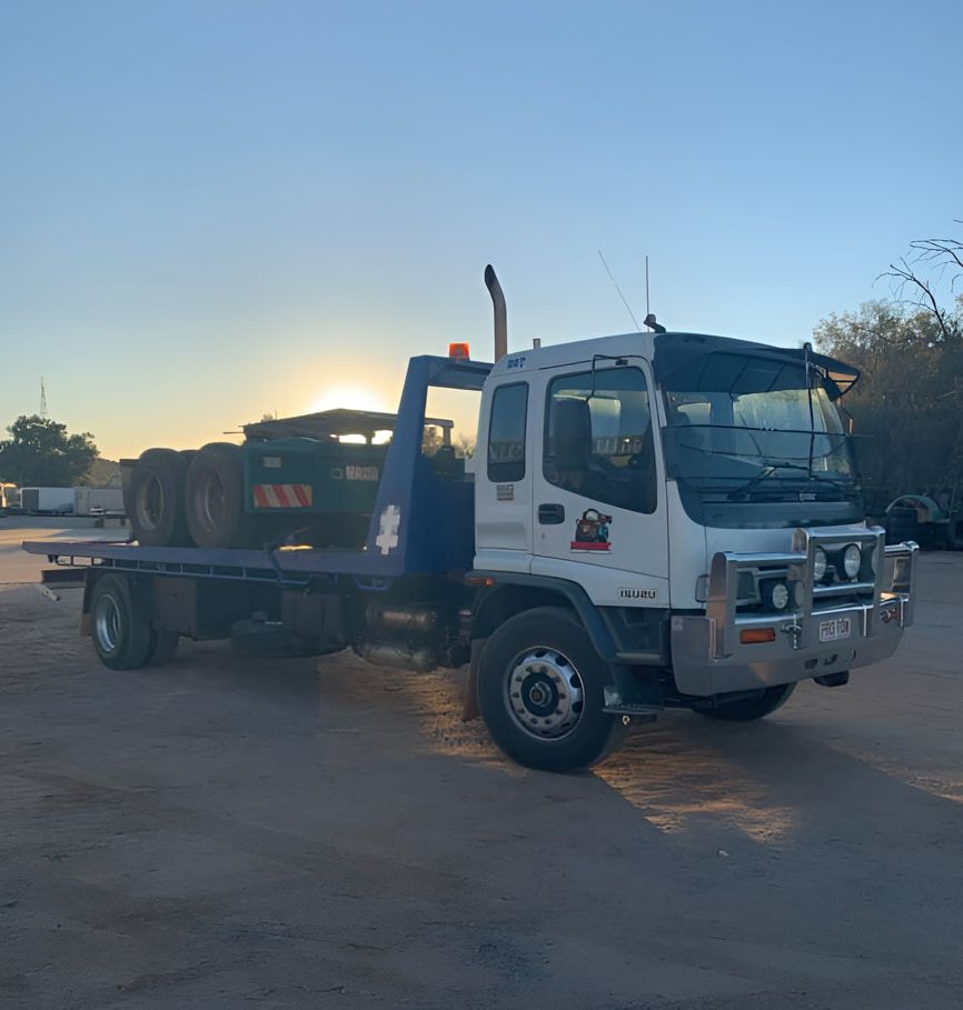 A White Tow Truck Is Parked In A Dirt Lot — Territory Towing & Transport In Alice Springs, NT