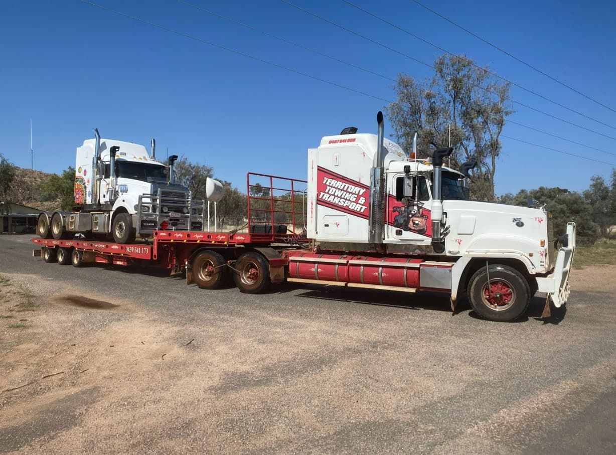 Two Semi Trucks Are Parked Next To Each Other On The Side Of The Road — Territory Towing & Transport In Alice Springs, NT