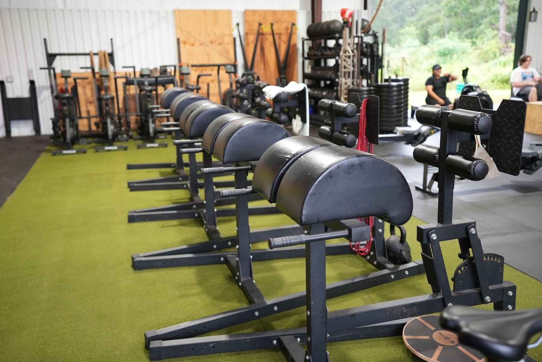 A row of gym equipment is lined up at CrossFit Threshold gym