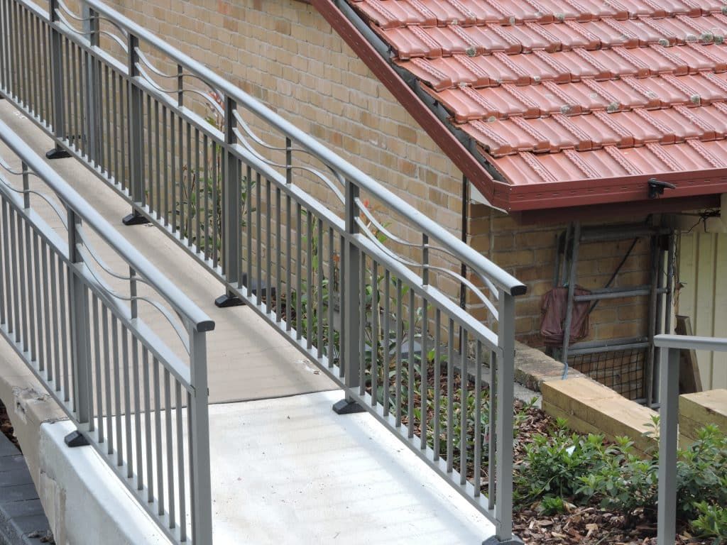 A Stairway With A Metal Railing In Front Of A House - Balustrade in Singleton, NSW