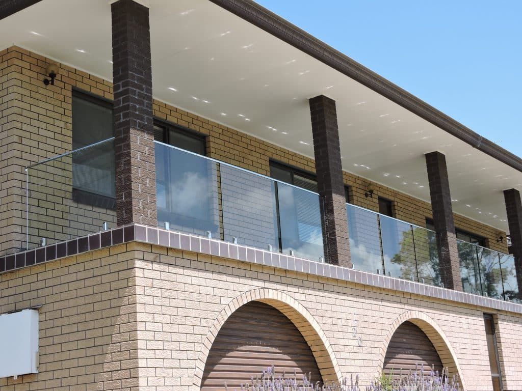 Brick House With Frameless Balcony Railing - Balustrade in Maitland, NSW