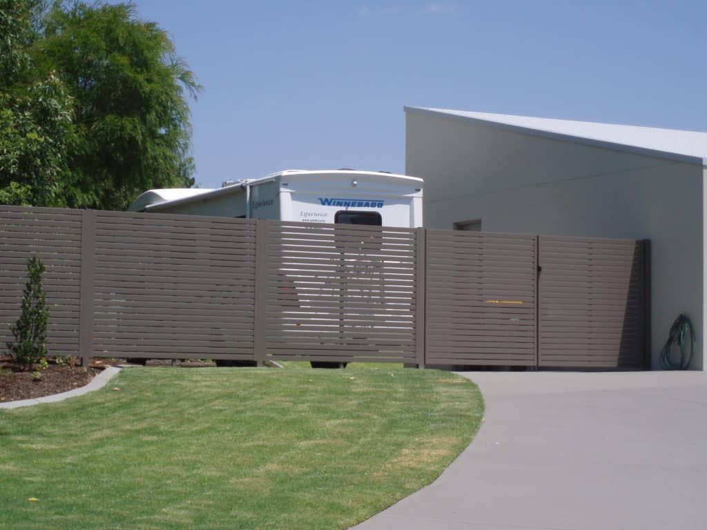 Brown Fence In Front Of A House - Newcastle Aluminium Manufacturer