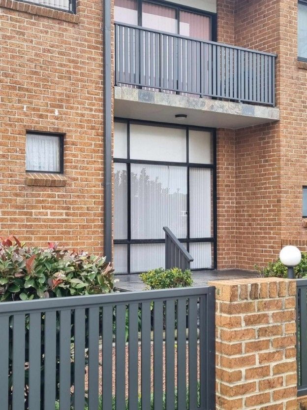 Metal Fences Around A Brick House