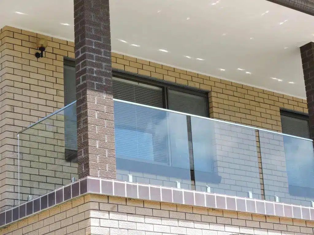 Bricks Balcony With Glass Railings - Aluminium Manufacturer in Newcastle, NSW