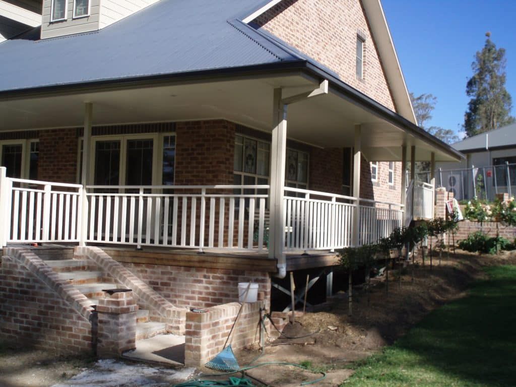 Brick House With A White Railing - Aluminium Manufacturer in Newcastle, NSW
