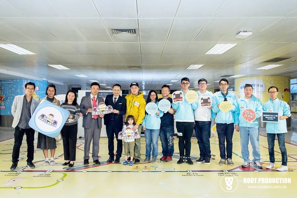Group of people holding signs in a brightly lit hallway.