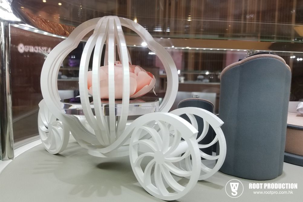 White ornamental carriage with large wheels and a floral interior display.