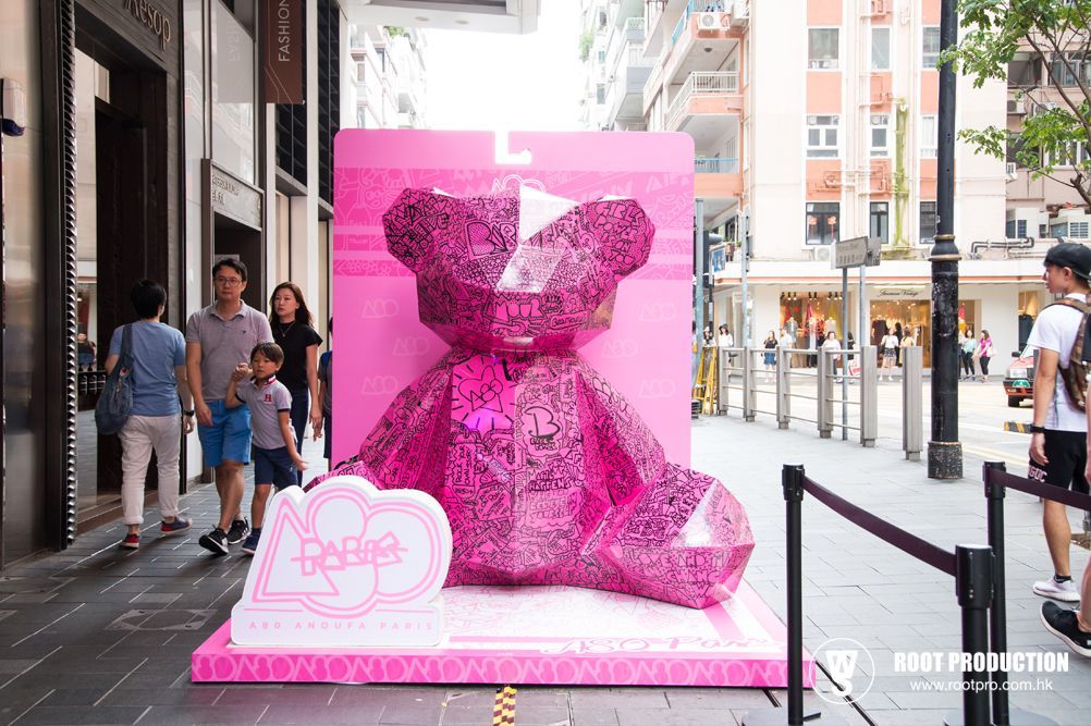 Large pink, faceted bear sculpture in a street display advertising Barbie.