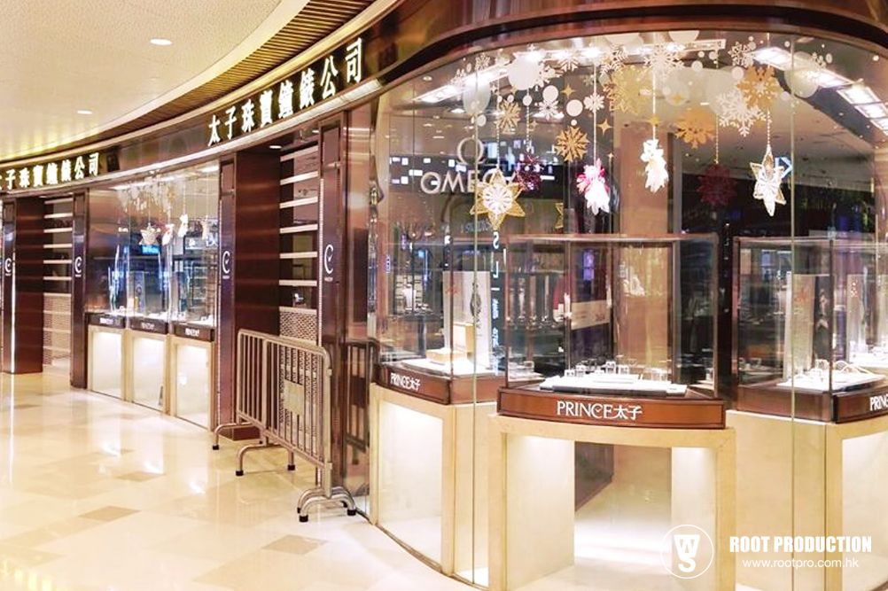 Luxury watch store with glass displays in a mall, gold and brown tones, holiday decorations.