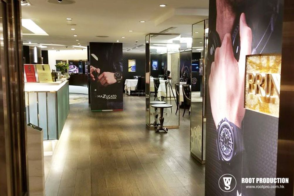 Interior of a watch store, showing displays, watches, and a mirrored hallway.