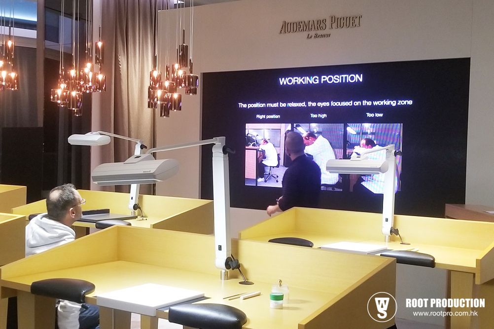 Workshop: People at workbenches, watching presentation on 