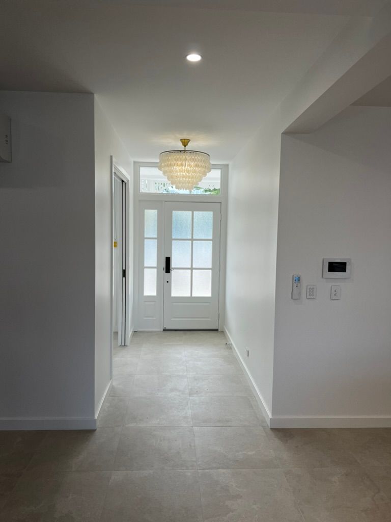 An Empty Room With a Vaulted Ceiling and a Window — Poljak Plasterers in Rosslea, QLD
