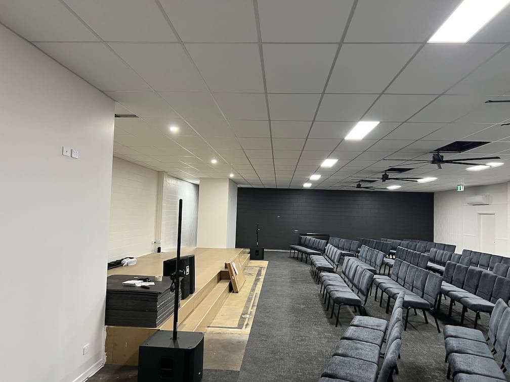 A Large Auditorium With Rows of Chairs and a Stage — Poljak Plasterers in Pimlico, QLD
