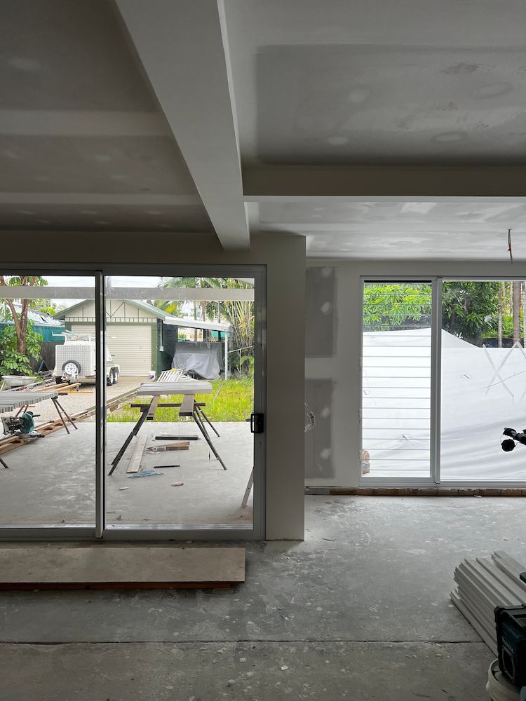 A Room With a Lot of Windows and a Sliding Glass Door — Poljak Plasterers in Belgian Gardens, QLD