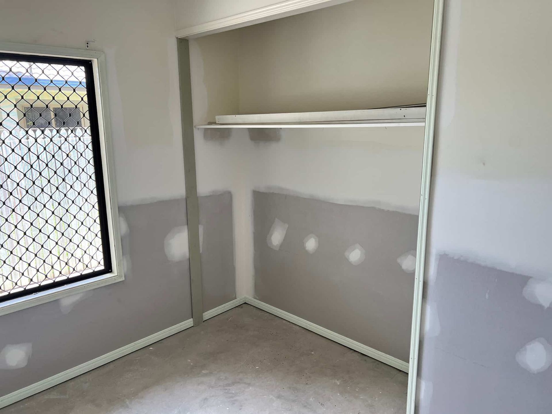 A Room With a Window and a Shelf in It — Poljak Plasterers in South Townsville, QLD