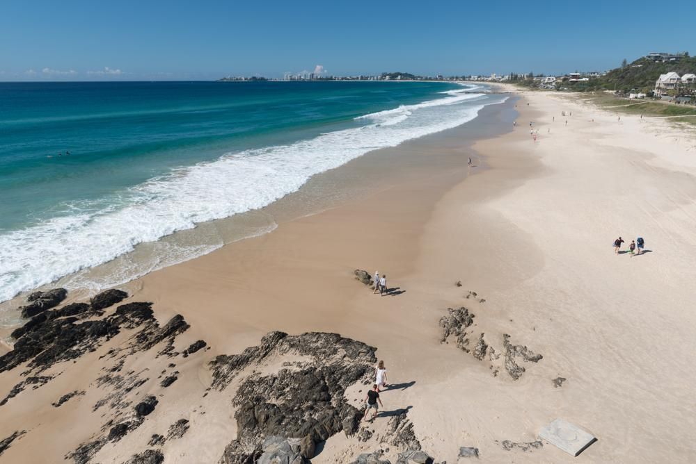 An Aerial View of a Beach With Rocks in the Foreground — Poljak Plasterers in Currajong, QLD
