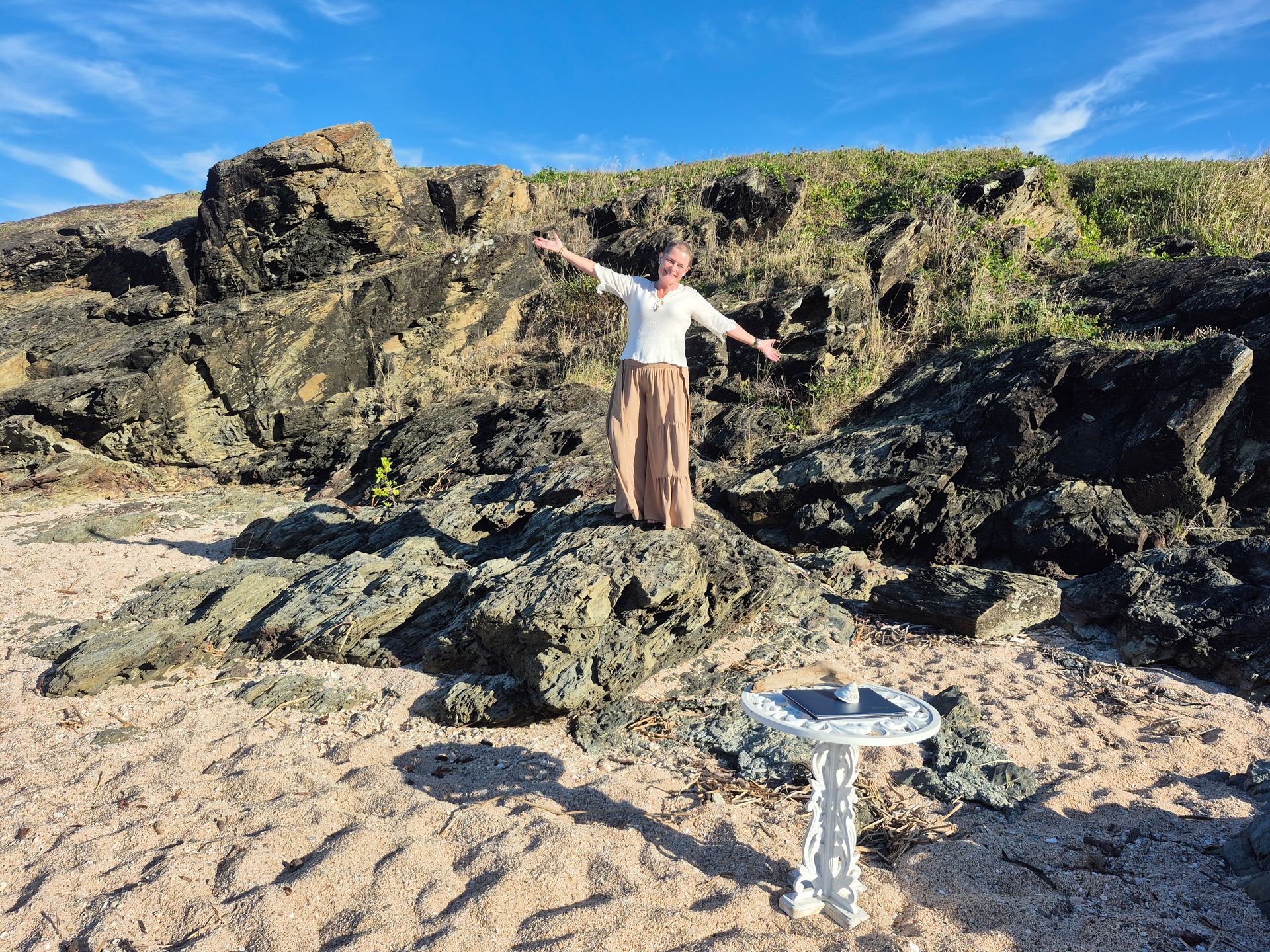 A Woman in a Long Dress is Standing in Front of a Balloon Arch — ‘Weddings on the Run’ – Elope with the Travelling Celebrant In Emu Park, QLD
