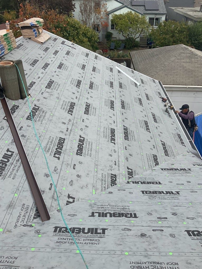 A roof with a lot of shingles on it is being built.