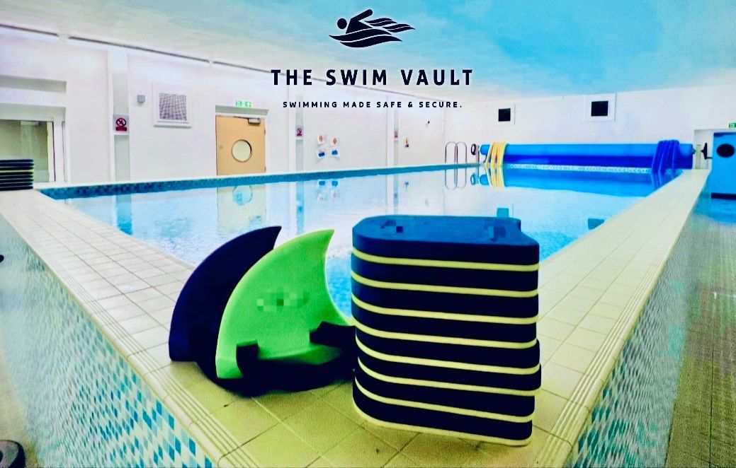 Poolside view with swim aids: hand paddles and kickboard at The Swim Vault.