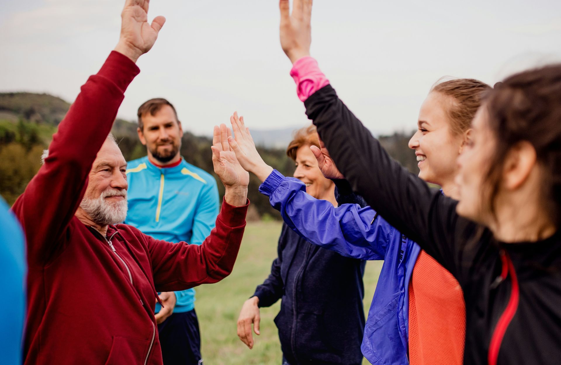 A group of people are giving each other a high five.