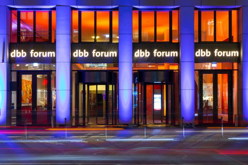dbb forum von außen in der Dämmerung, mit blau erleuchteten Eingangssäulen