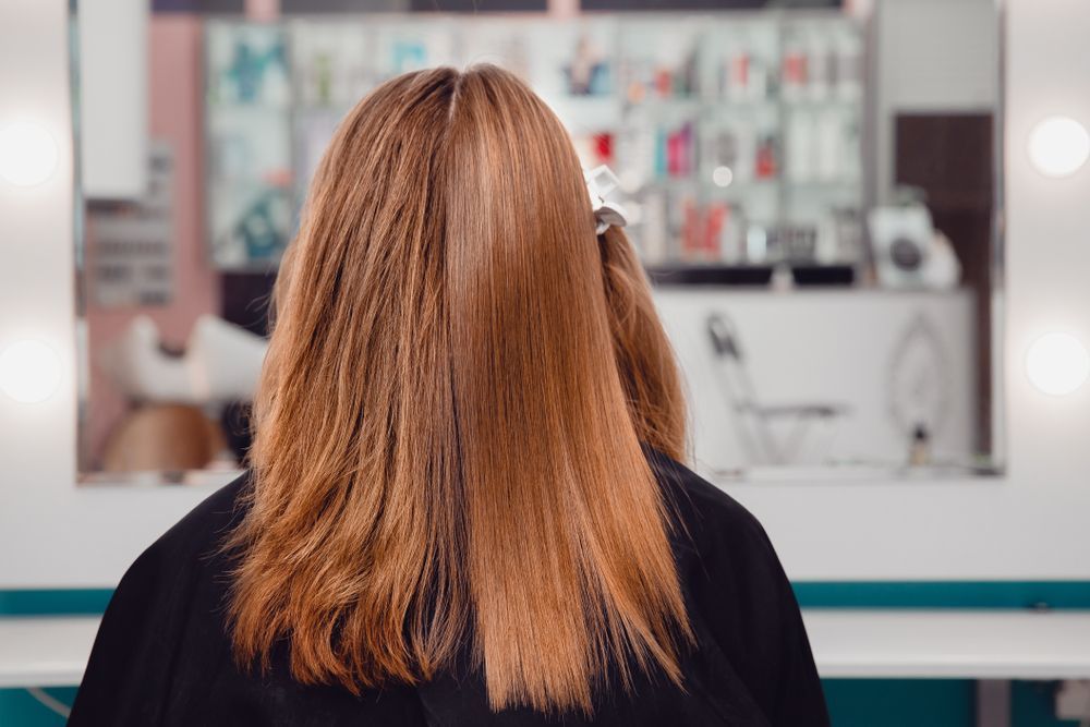 Person With Long Auburn Hair Facing a Mirror in a Salon Interior — @miilan in Darwin City, NT