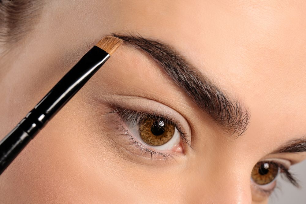 Eyebrow Being Shaped With a Brush Near a Woman's Eye, Close-up — @miilan in Darwin City, NT