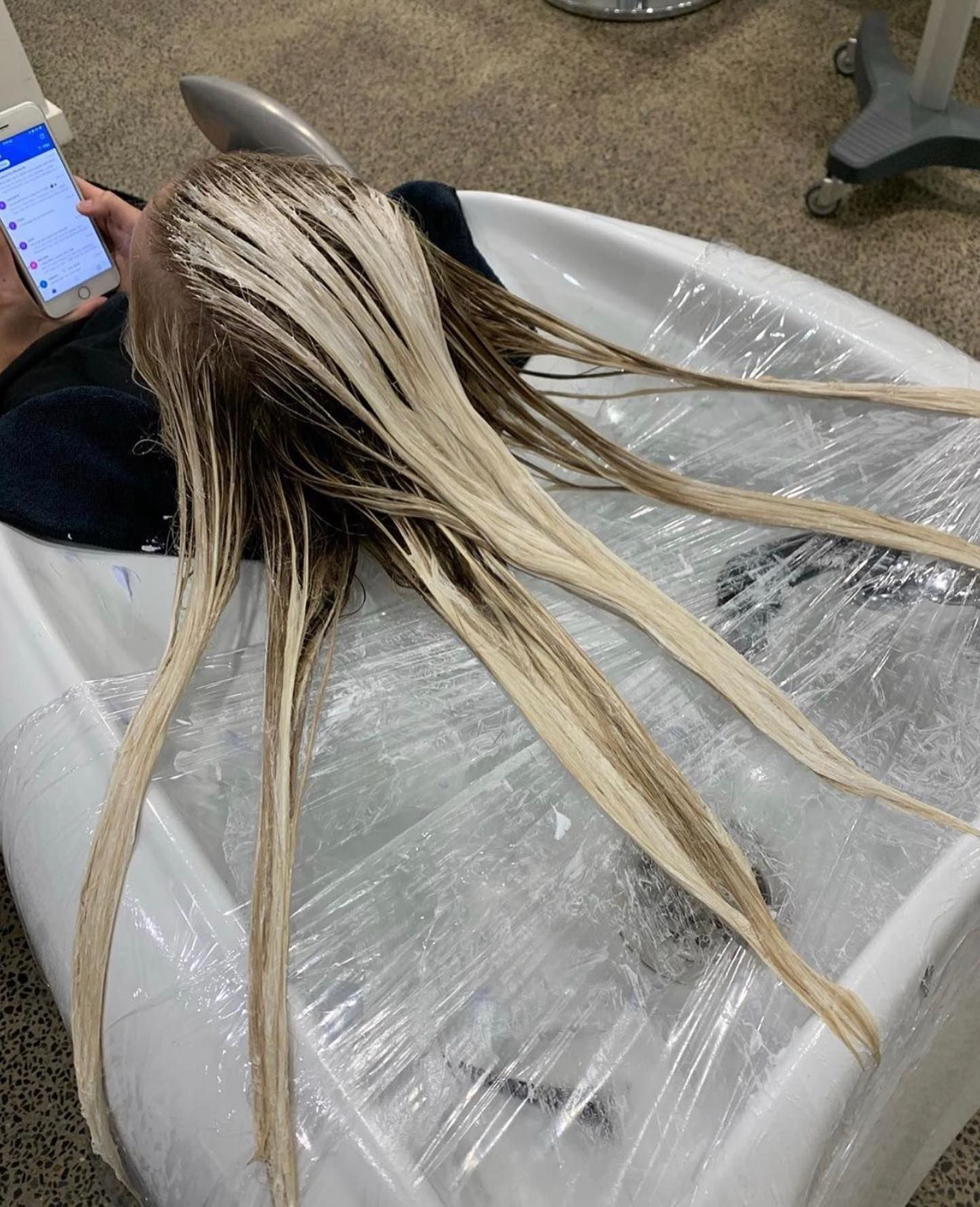Hairdresser Applying Foil Highlights to a Client’s Brown Hair in a Salon — @miilan in Darwin City, NT