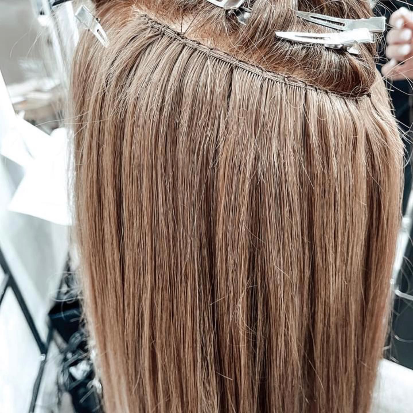 Stylist Sectioning Blonde Hair for Treatment Near a Salon Mirror — @miilan in Darwin City, NT