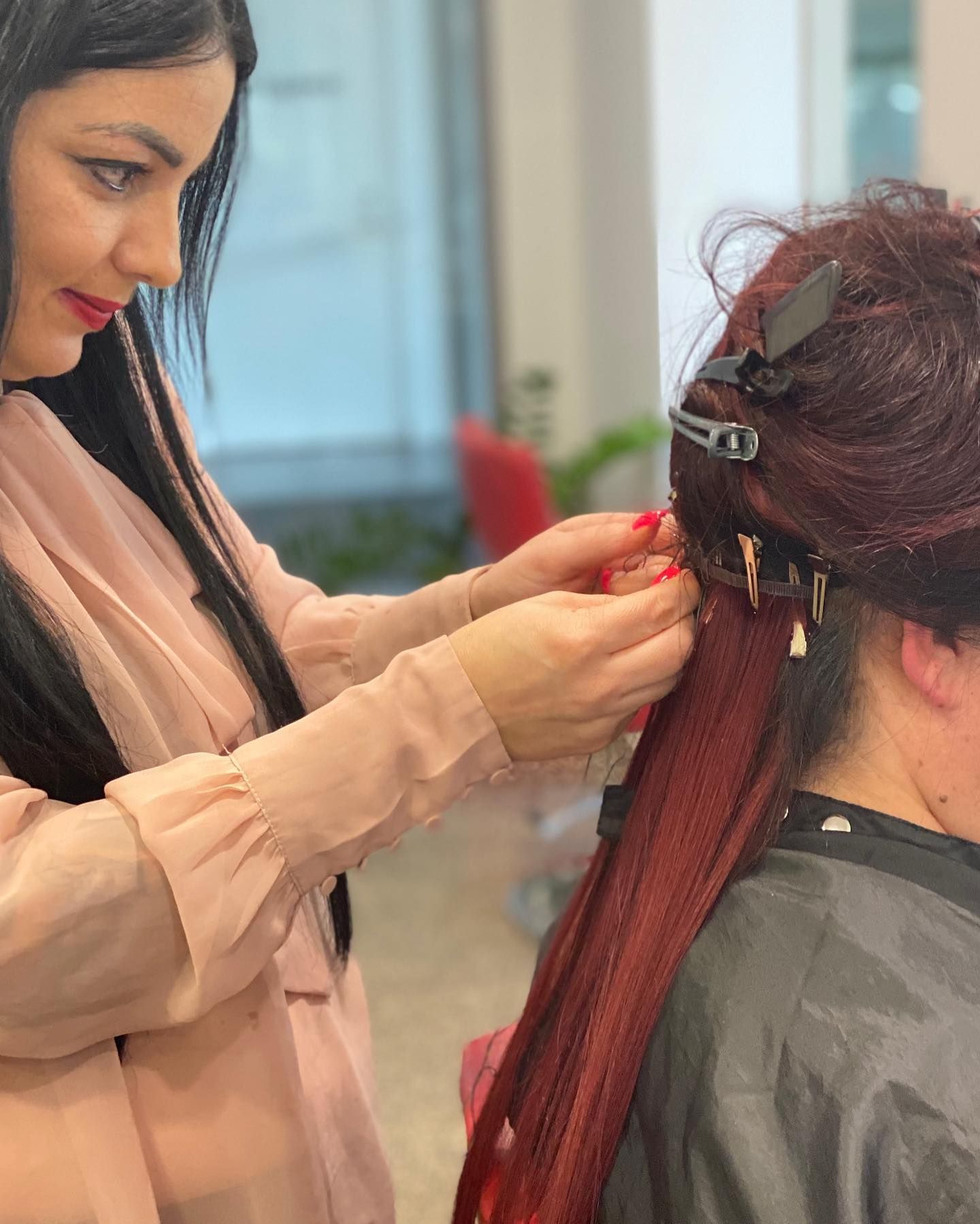Stylist Braiding Long Blonde Hair in a Salon Chair — @miilan in Darwin City, NT