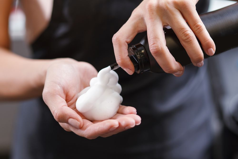Hands Dispensing White Foam SOAP Into Another Person's Cupped Hand — @miilan in Darwin City, NT