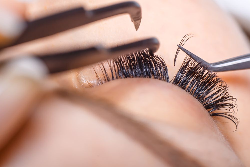 Close-up of Tweezers Applying False Eyelashes to a Closed Eye — @miilan in Darwin City, NT