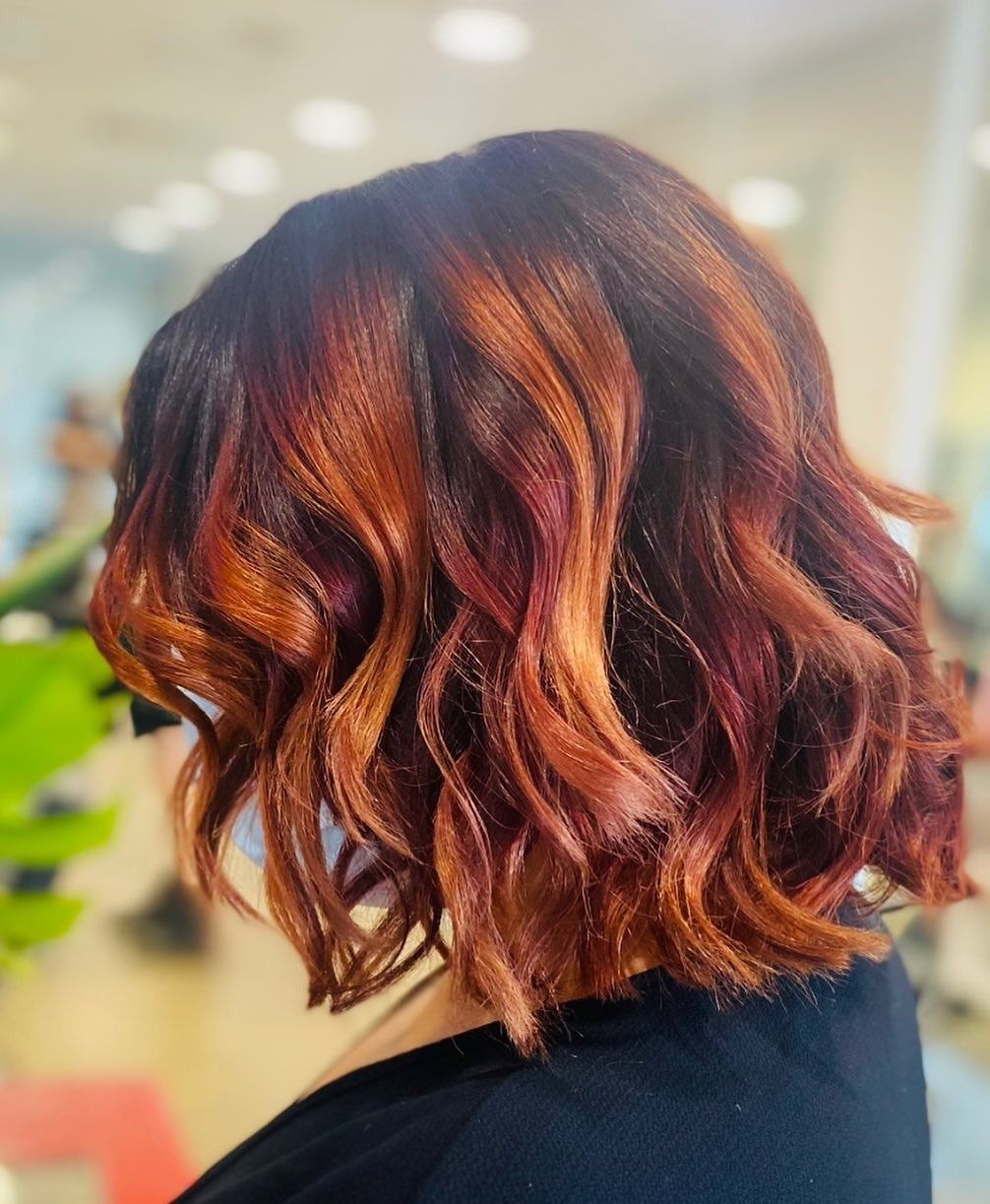 Stylist Curling a Blonde Updo With a Red Curling Iron in a Salon — @miilan in Darwin City, NT