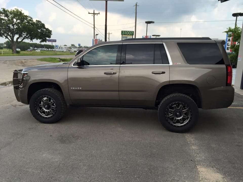 A gray suv is parked in a parking lot